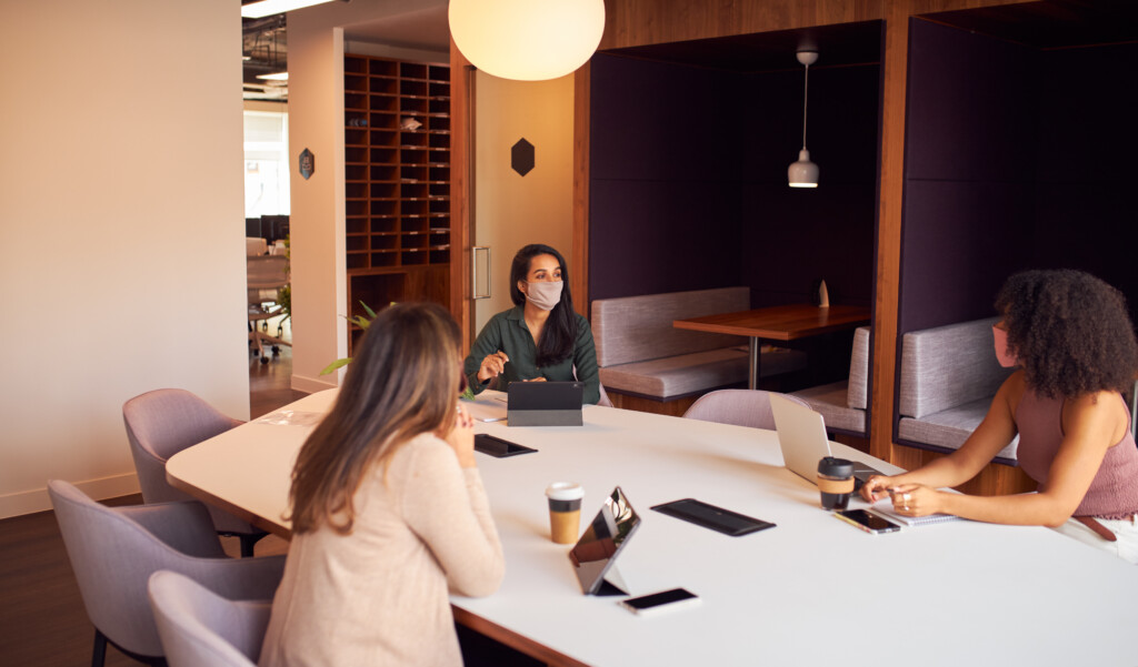 Socially distanced meeting, office space, masked, meeting, image by Adobe Stock