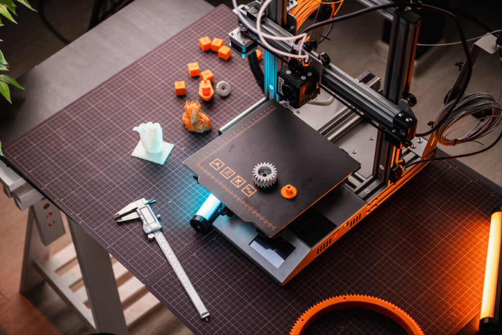 3D printer in the laboratory top view, 3D printer in the process. 3d printer close-up blue and orange backlight. High quality photo, IoT Camera, Lensley Studio